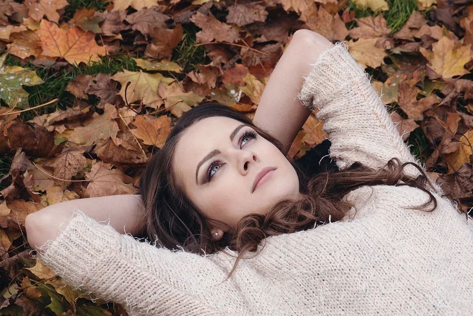 Woman lying on leaves