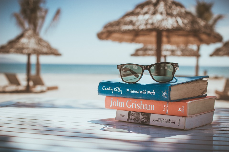 Pile of books on beach