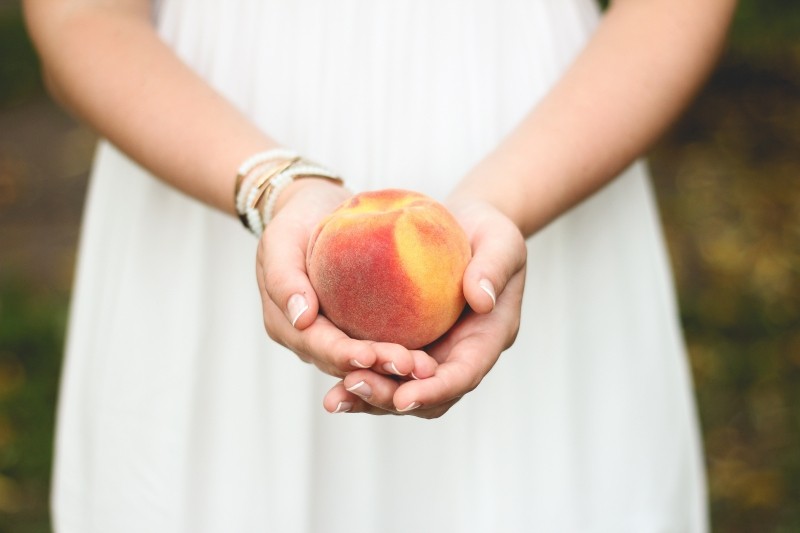 Girl holding peach