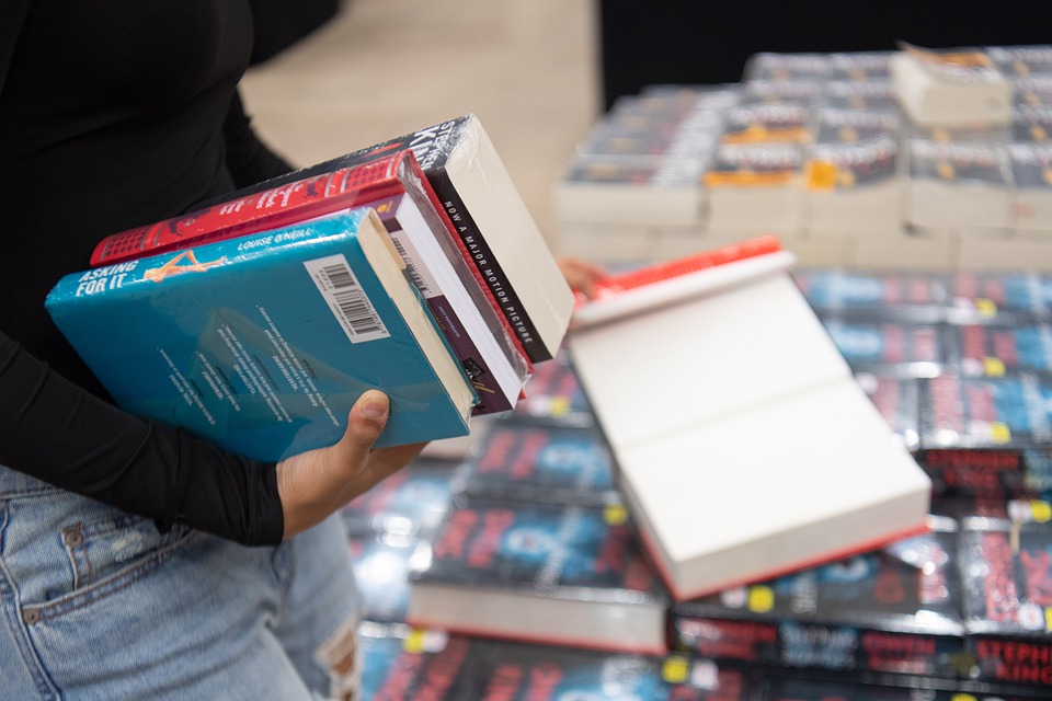 Girl holding pile of books