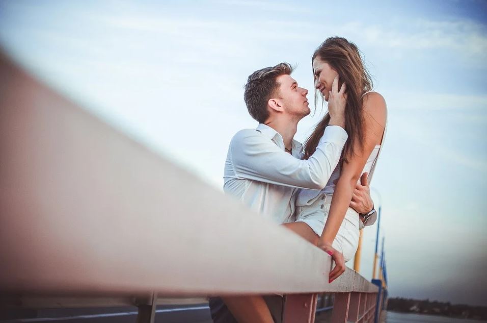 Couple sitting on fence