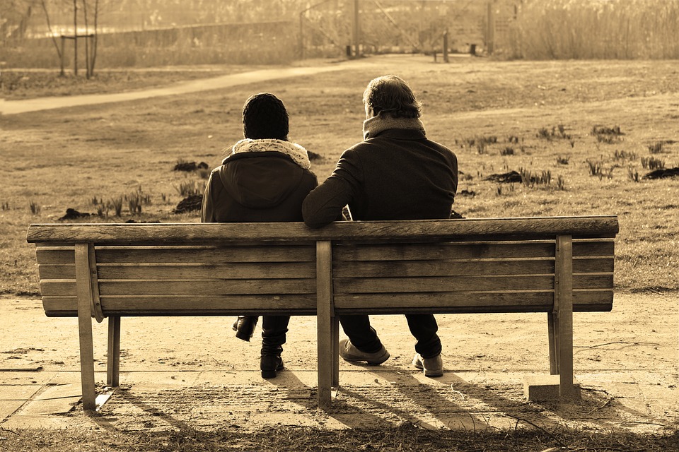 Couple talking on bench