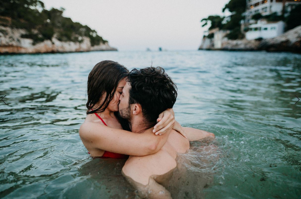 Couple kissing in water