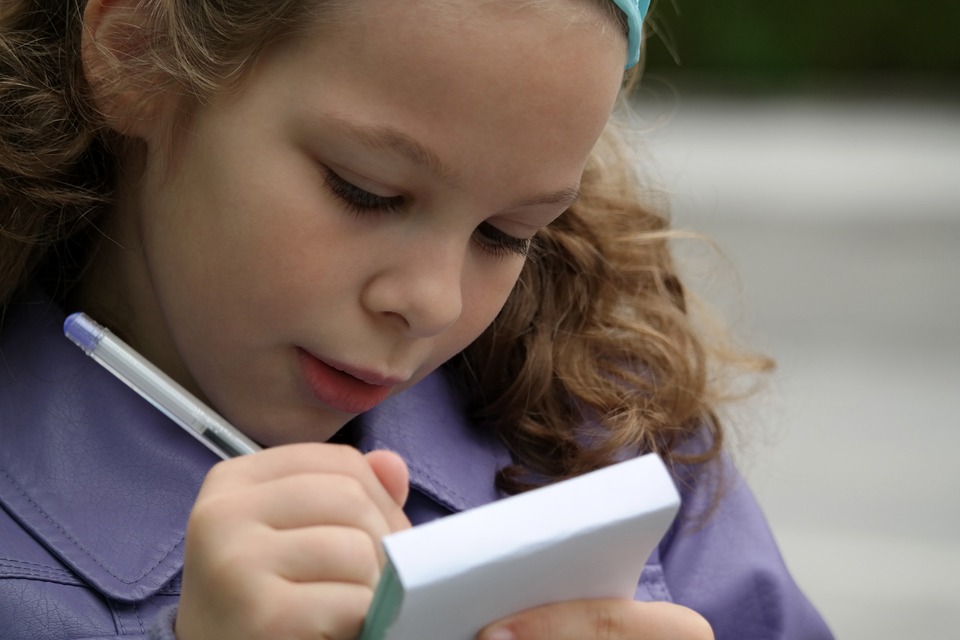 Young girl writing in a notebook