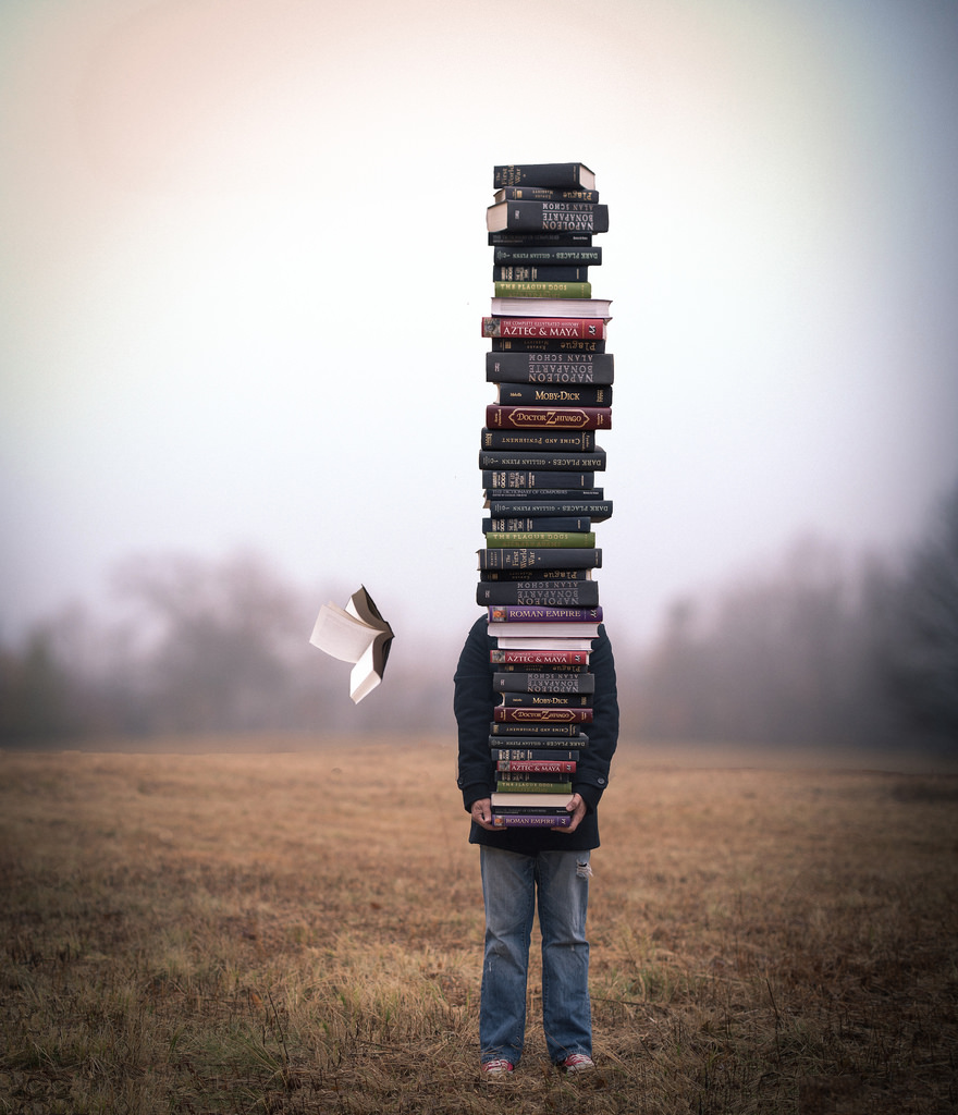 Holding a big pile of books