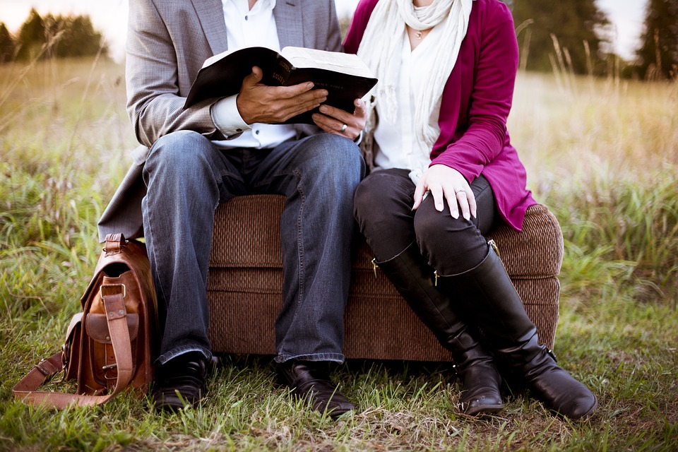 Couple sitting on couch reading