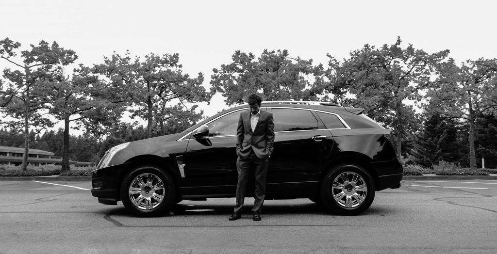 Man in suit with fancy car