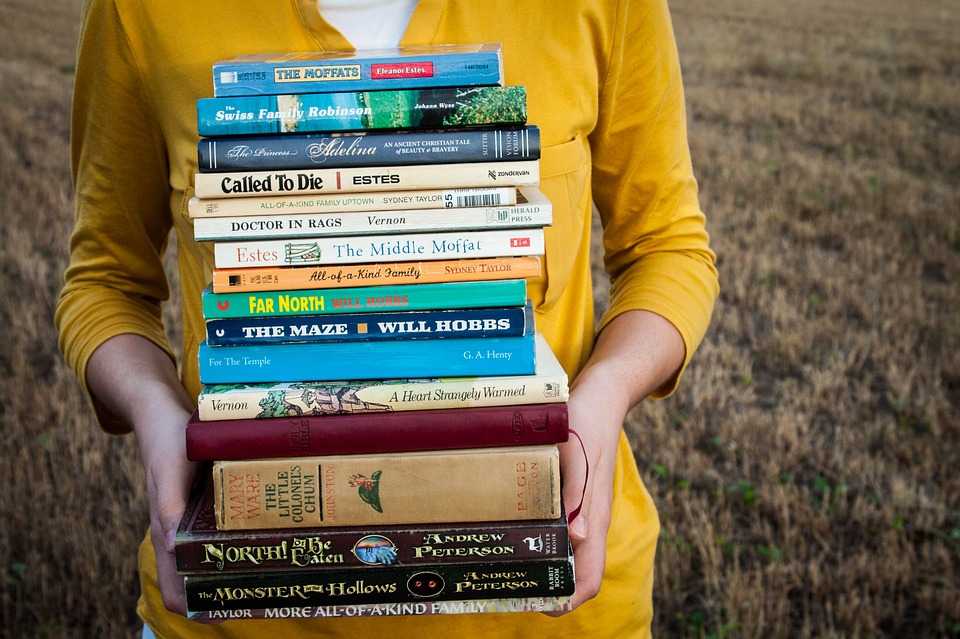 Girl with big pile of books