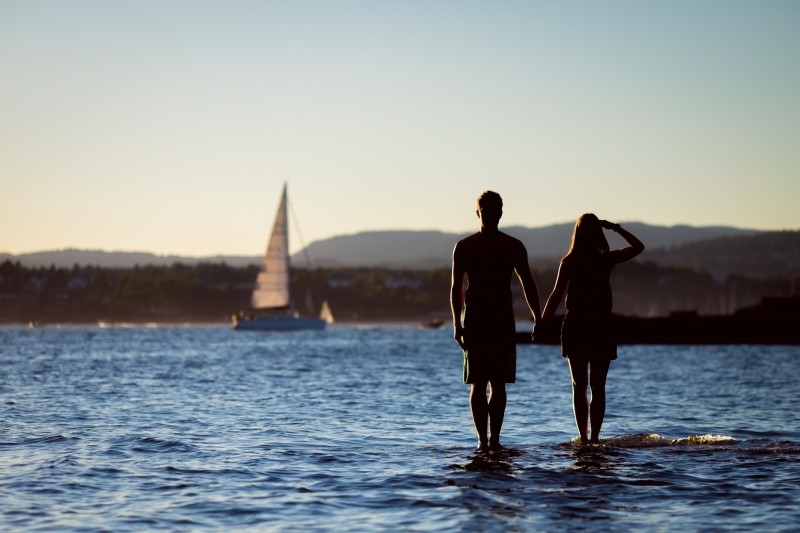 Couple standing with sailboat