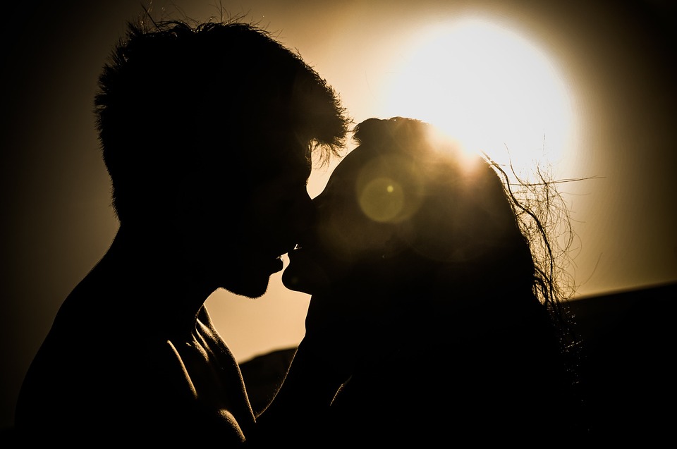 Couple kissing in sunset