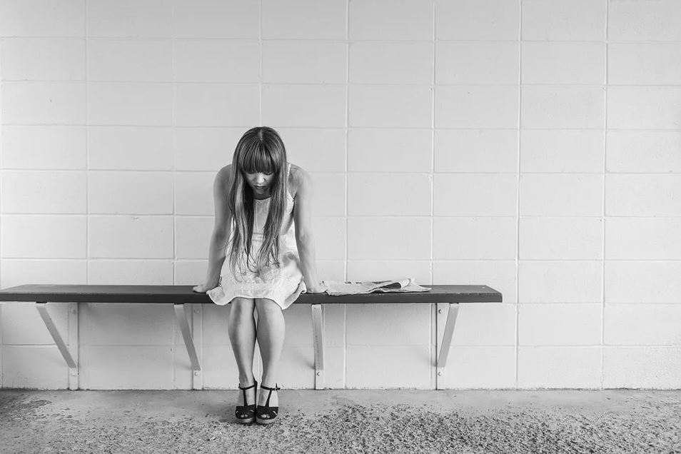 Girl thinking on bench