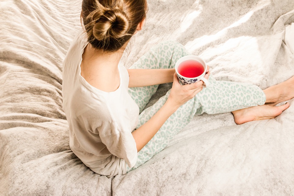 Girl in bed with tea