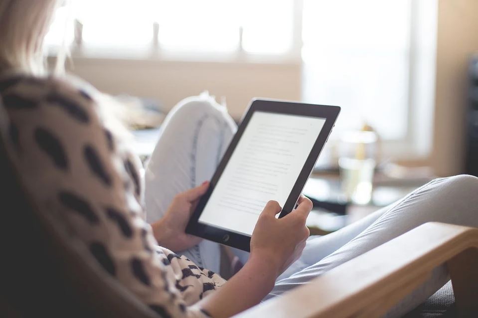 Woman reading on Kindle