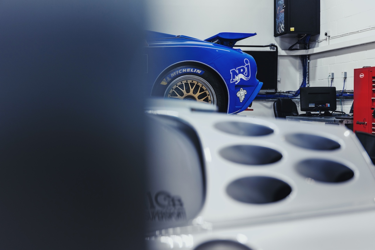Two Bugatti EB110 racers arrive at H.R. Owen Bugatti's workshop