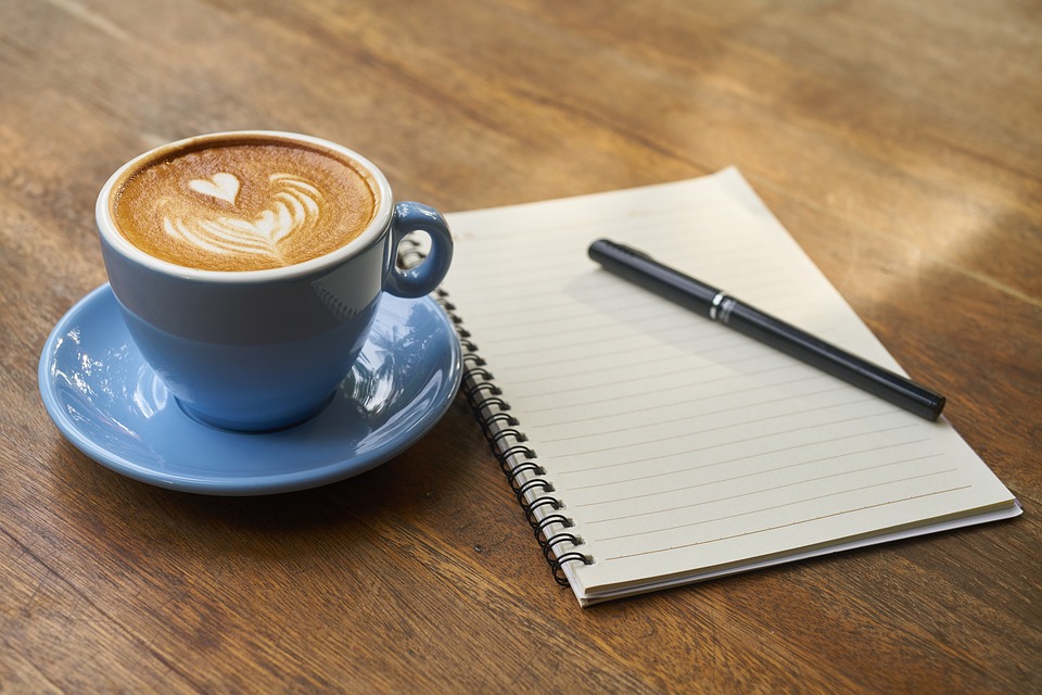 Notebook with cup of coffee