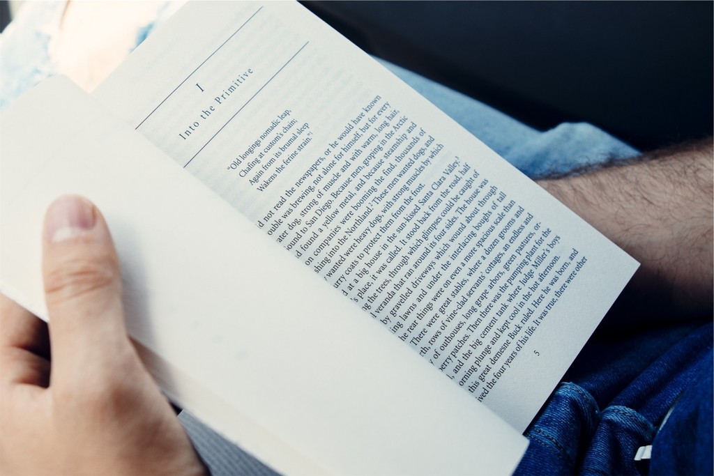 Guy reading holding pages