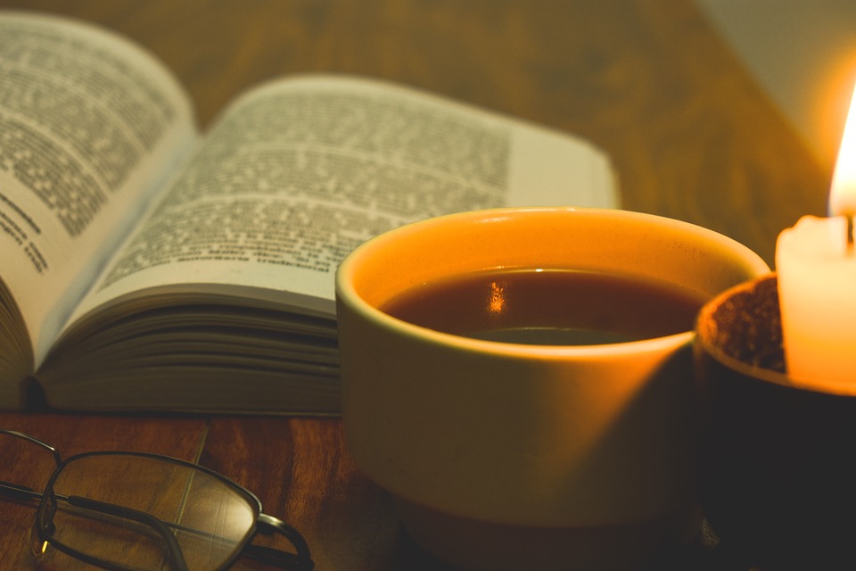 Book with coffee cup and candle