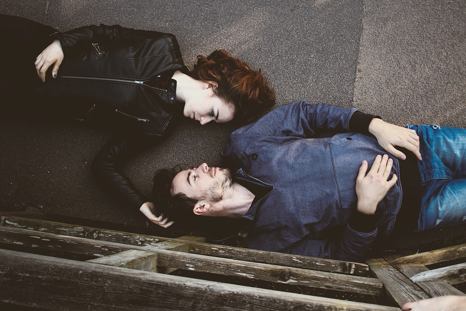 Couple lying down facing each other