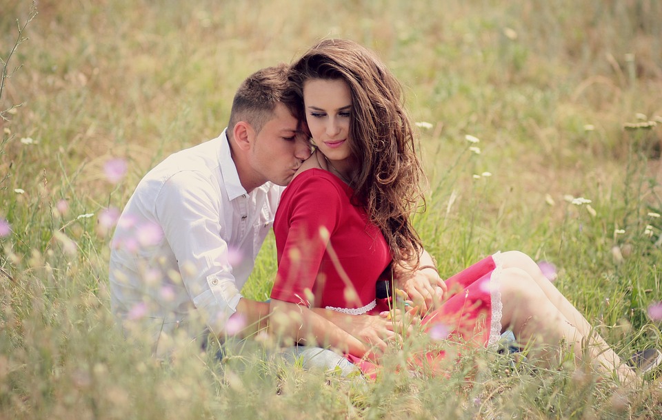 Couple kissing in a red dress