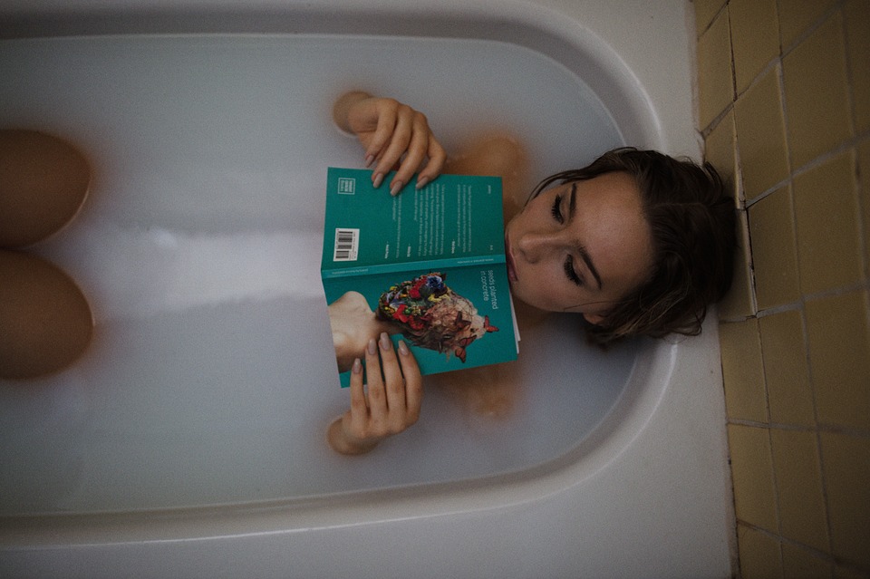 GIrl in bath reading