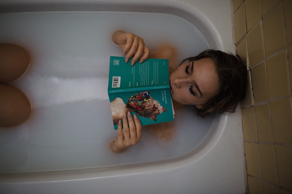 Girl in bath reading