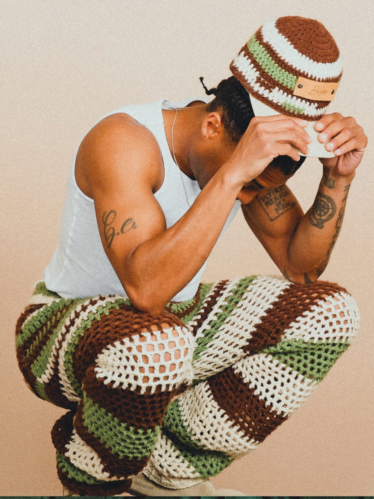 Byron adjusting a crocheted cap