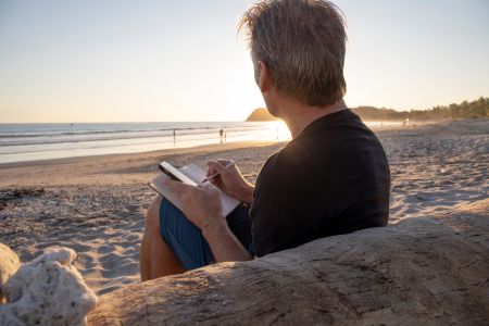 Man writing on beach