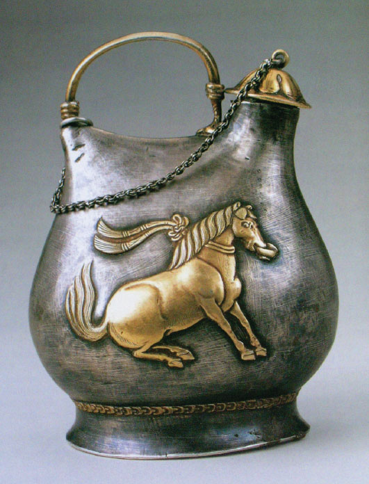 Silver Flask with Gilt Dancing Horse Holding a Cup in Its Mouth. Tang dynasty. 549 g. Shaanxi History Museum. Excavated from the Hejia Village hoard, 1970.
