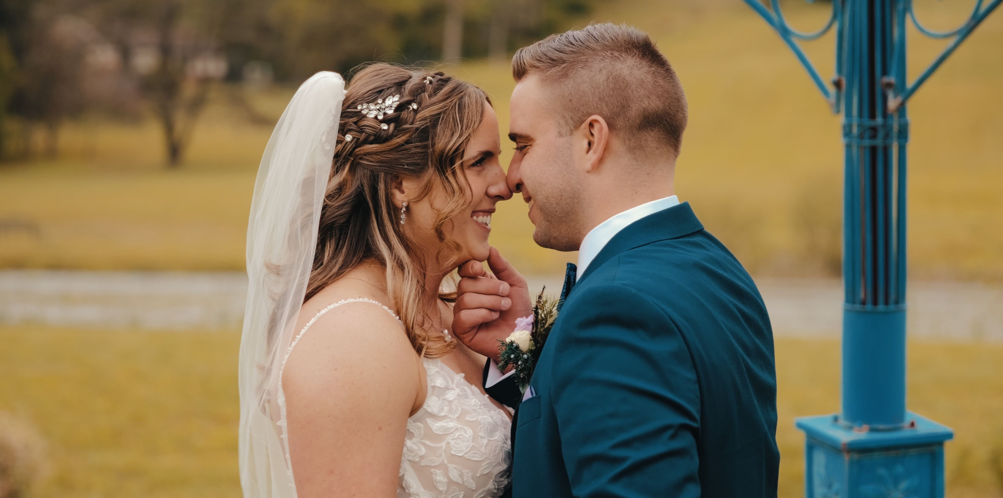 A couple laughing together in the middle of a crowded reception