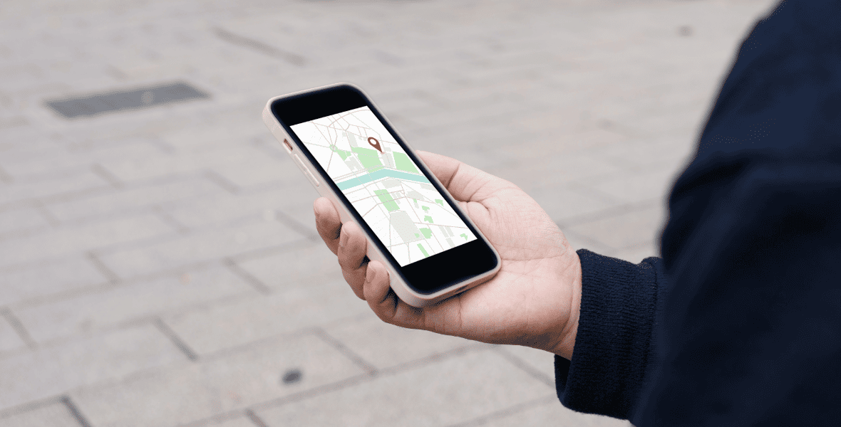a guy holding a phone with a map open