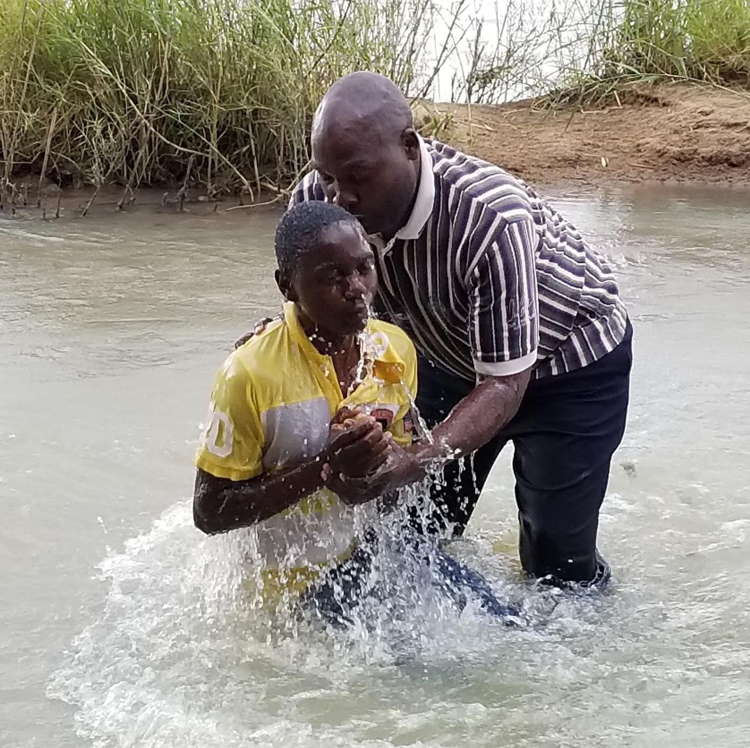 river baptism, boy getting baptized in river