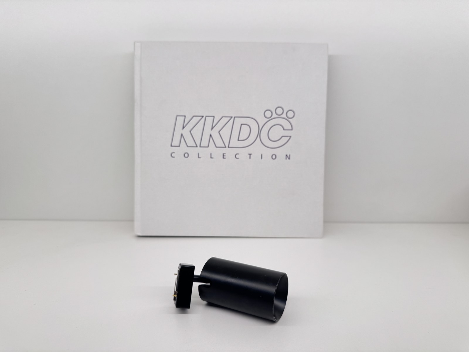 Mini Magnet — studio product shot with KKDC book
