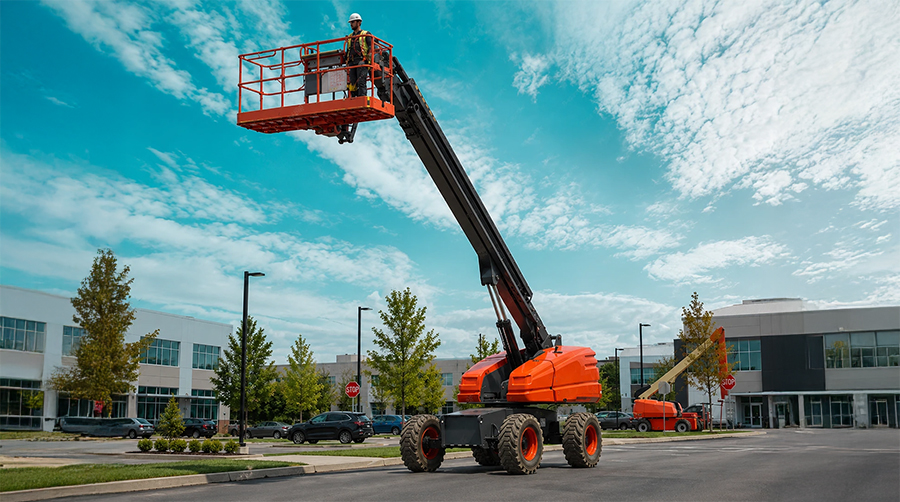 blog-11.jpg Worker operating a manlift at an outdoor construction site.
