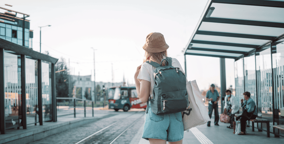 lady with a backpack at a tram station