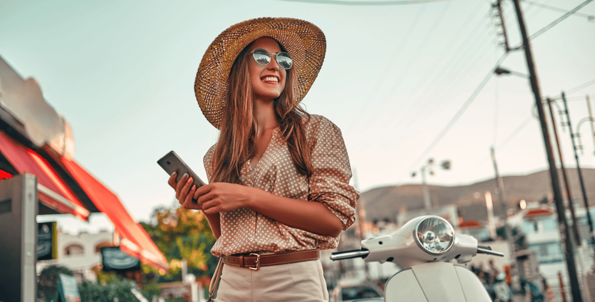 lady smiling and holgin a phone