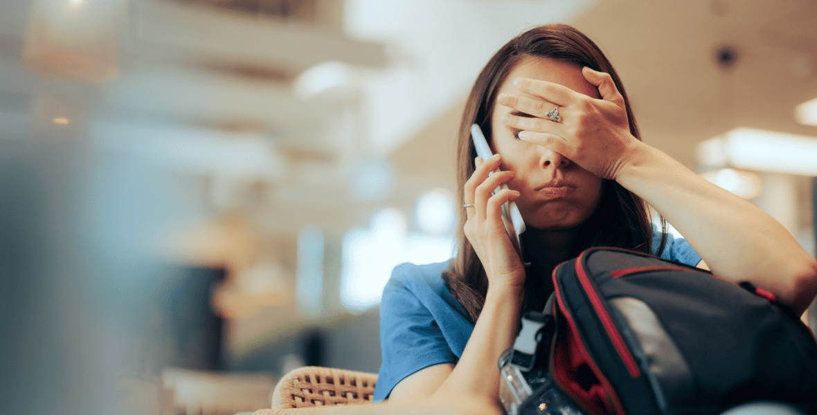 a sad traveler holding her face