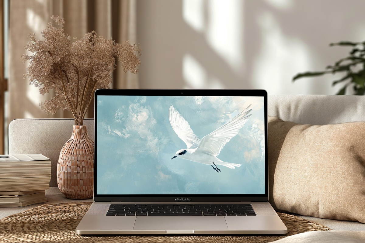 Elegance in Flight Silhouette Desktop Wallpaper featuring a single bird in minimalist flight against an airy background