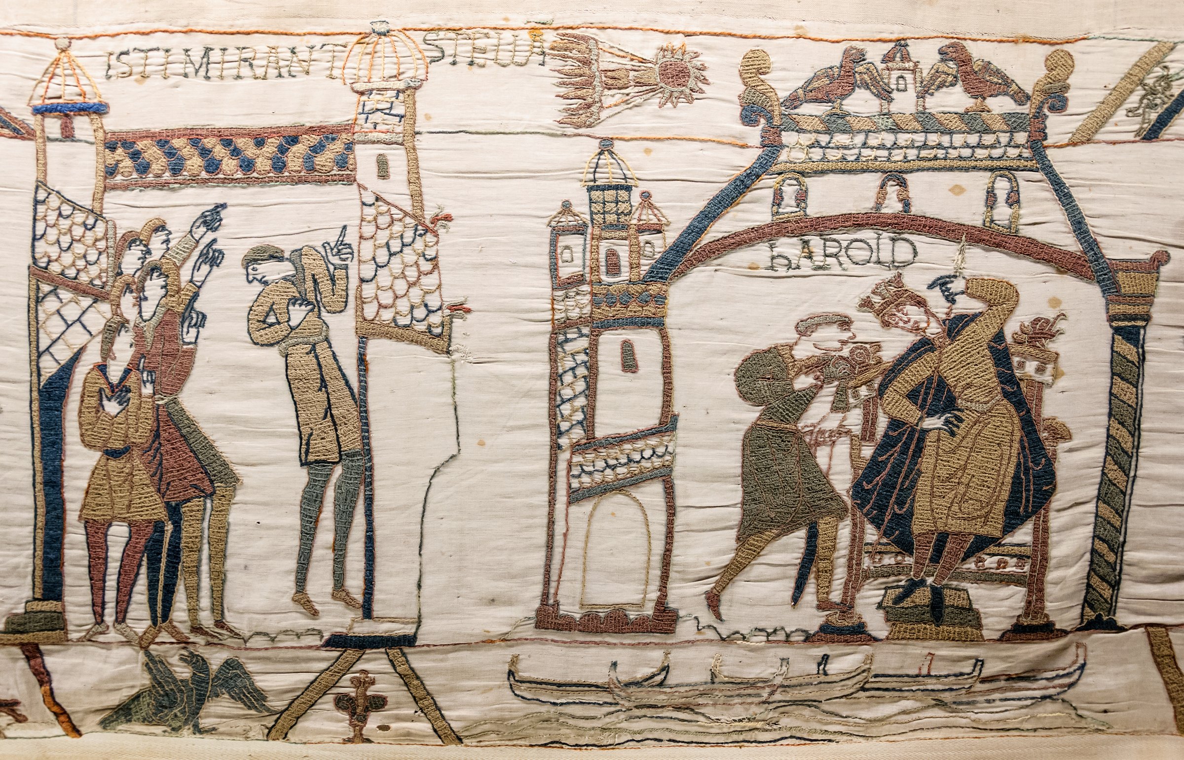 Bayeux Tapestry, scenes 32-33: Halley's Comet appears over England in April 1066, watched by frightened Anglo-Saxons. The embroiderers have caught the comet in mid-flight, with the tail trailing across the linen cloth.