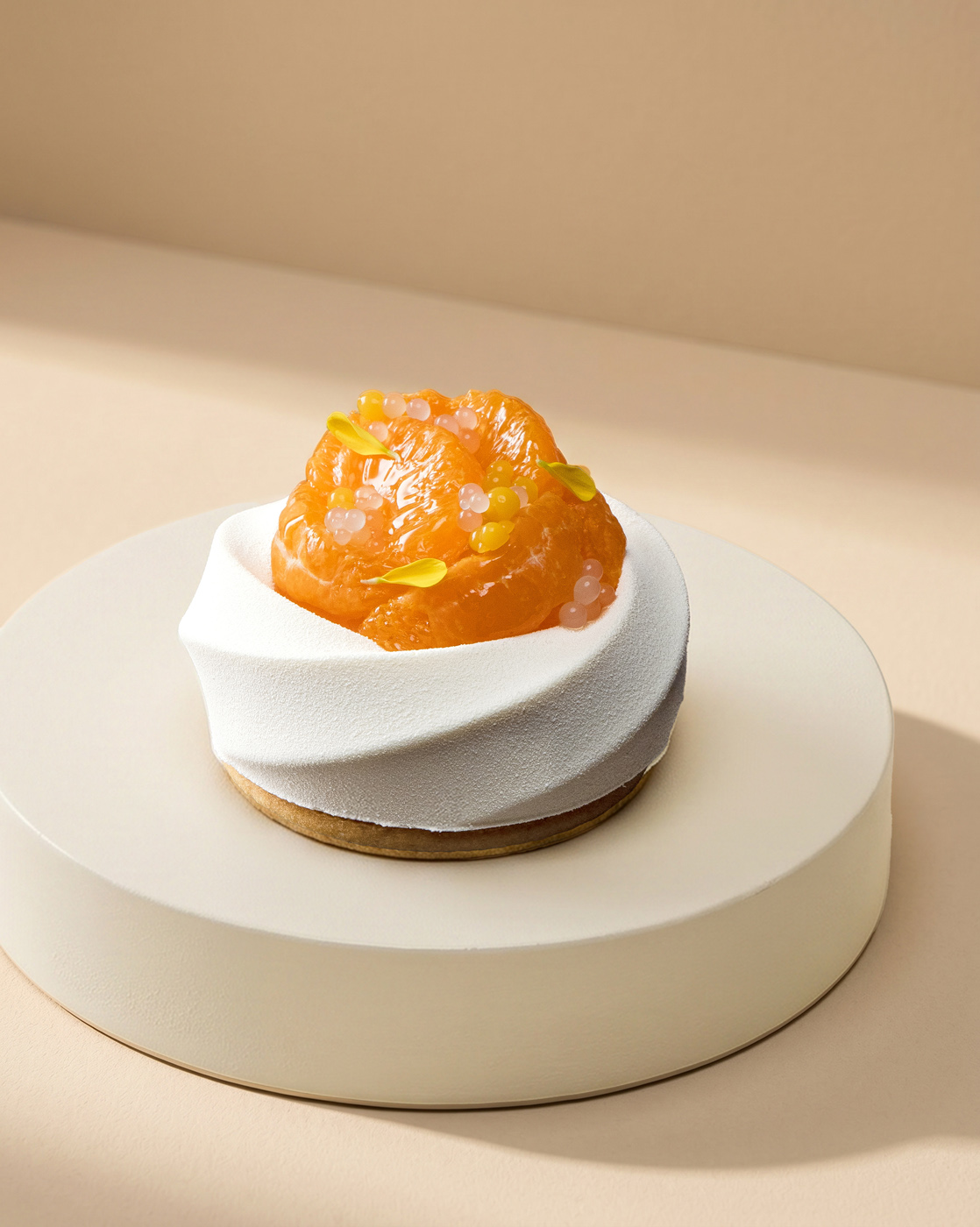 A meticulously crafted dessert featuring vibrant orange citrus segments atop a textured white mousse, elegantly presented on a soft beige platform. Flambient lighting highlights the freshness and intricate design.