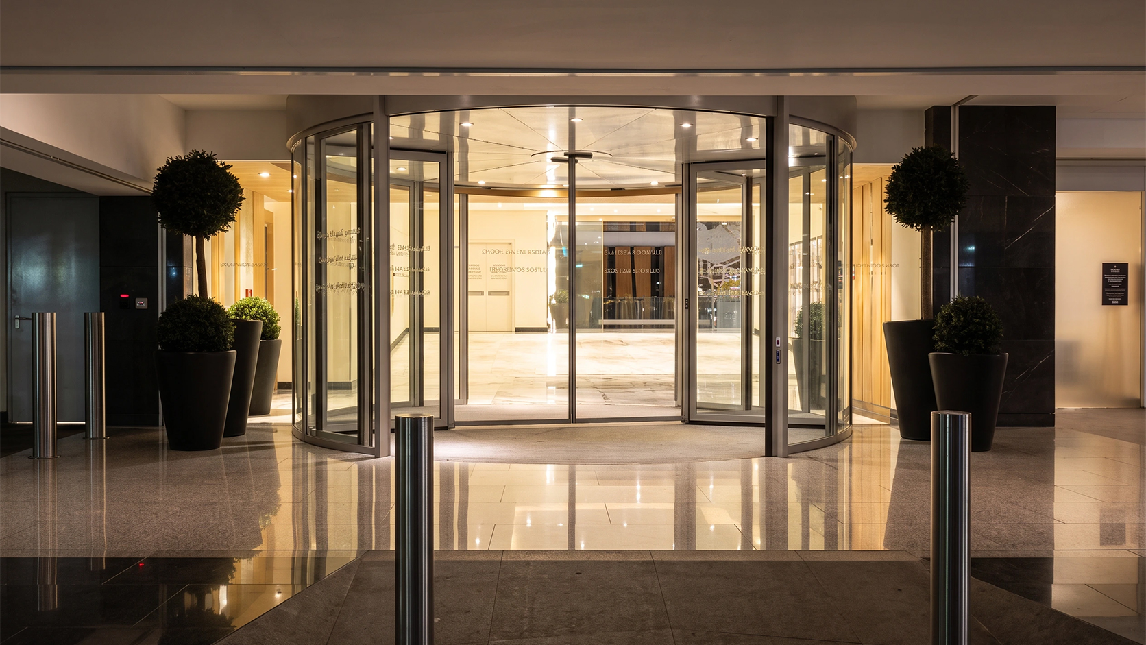 Dubai Mall entrance featuring a modern revolving glass door and luxury interior