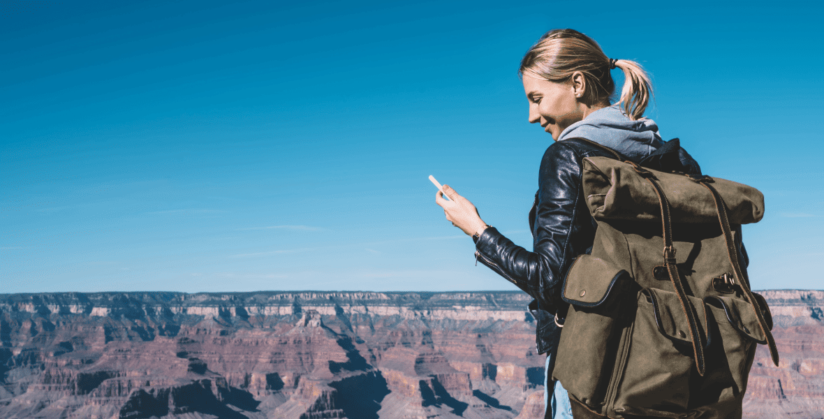 blonde lady smiling and holding a phone