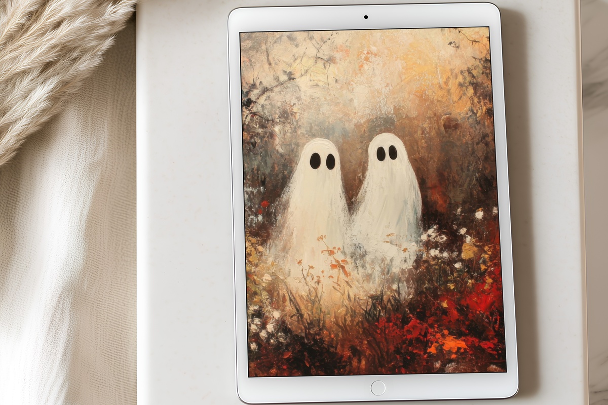 Spectral Duo in Autumn Radiance Halloween iPad Wallpaper with warm amber ghost figures
