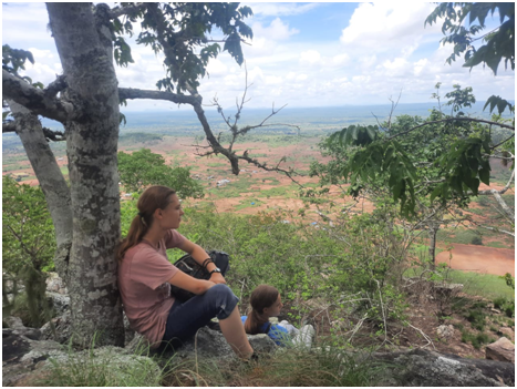 woman sitting under a tree, Maggie and Jane on a mountain hike.